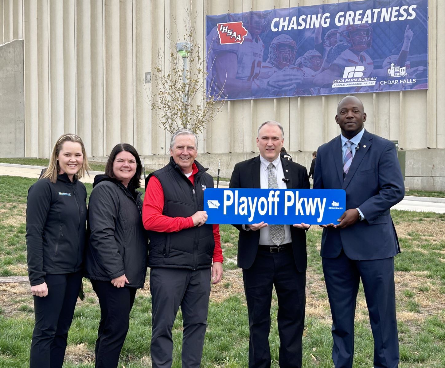 Officials with Playoff Parkway Sign