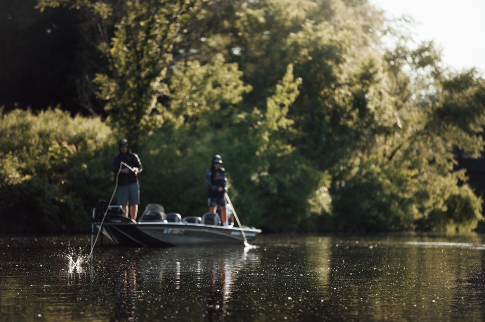 two people fishing from boat