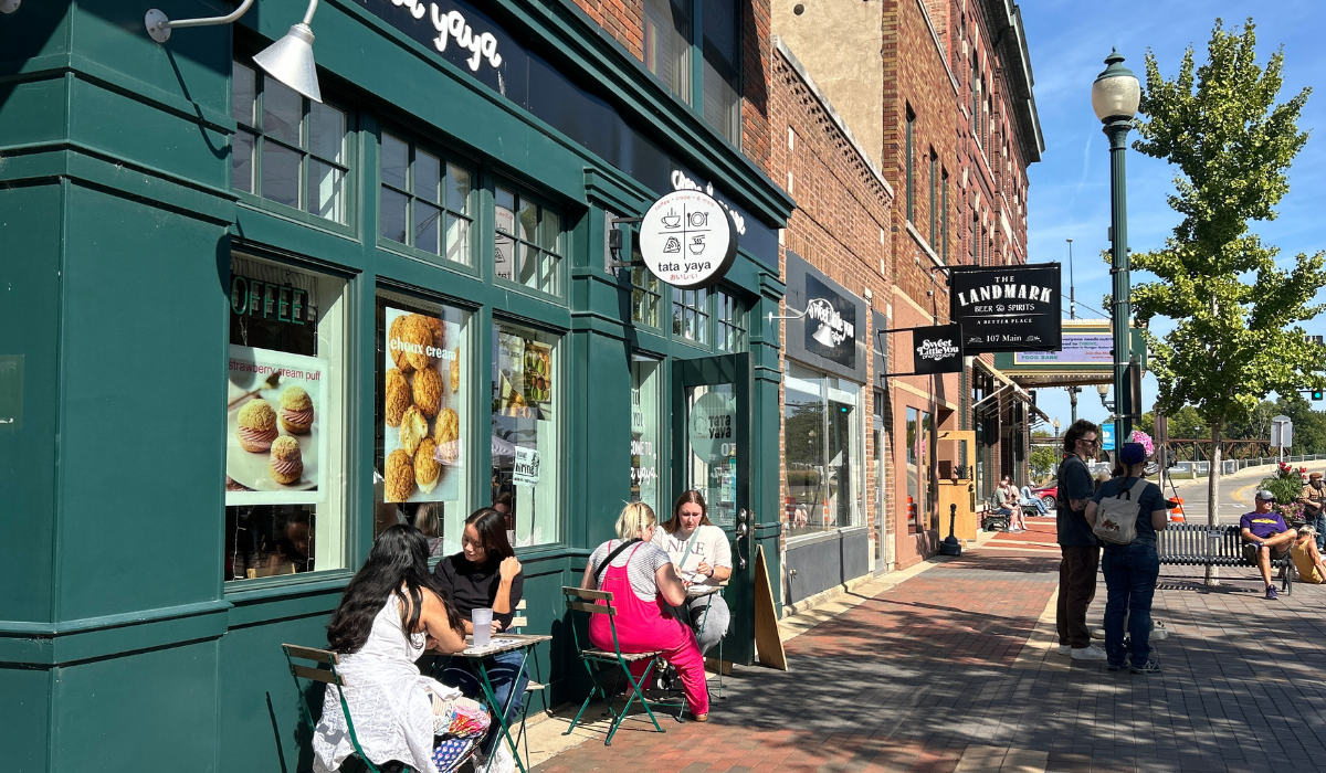 sidewalk seating at coffee and crepe shop on downtown street