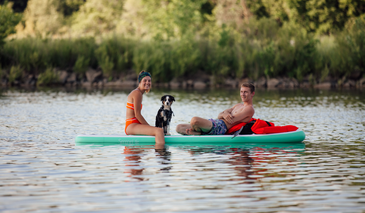 couple with dog in kayak